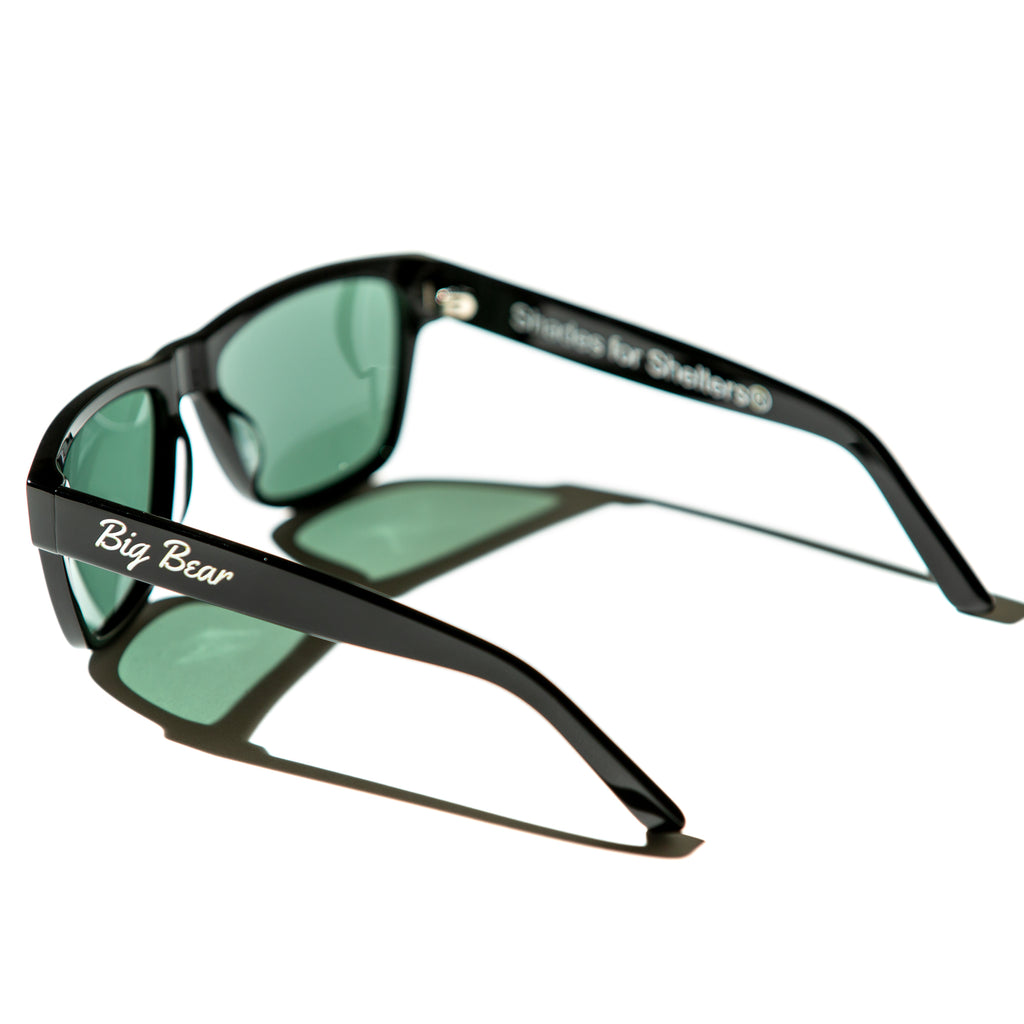 Green lens sunglasses with polished black temples