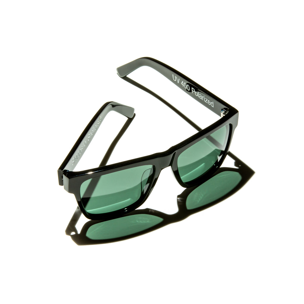 Green lens sunglasses with polished black temples