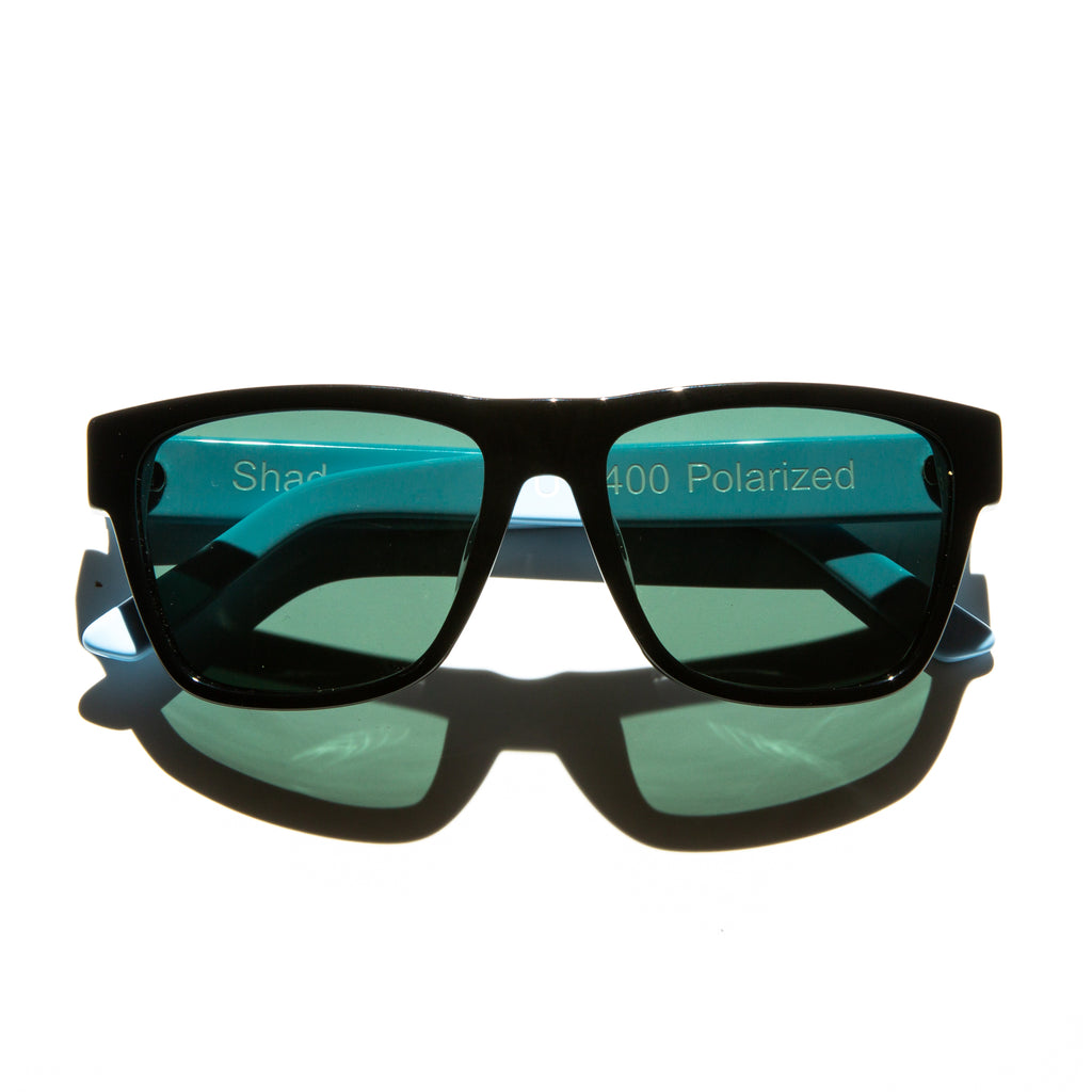 Green lens sunglasses with polished blue temples