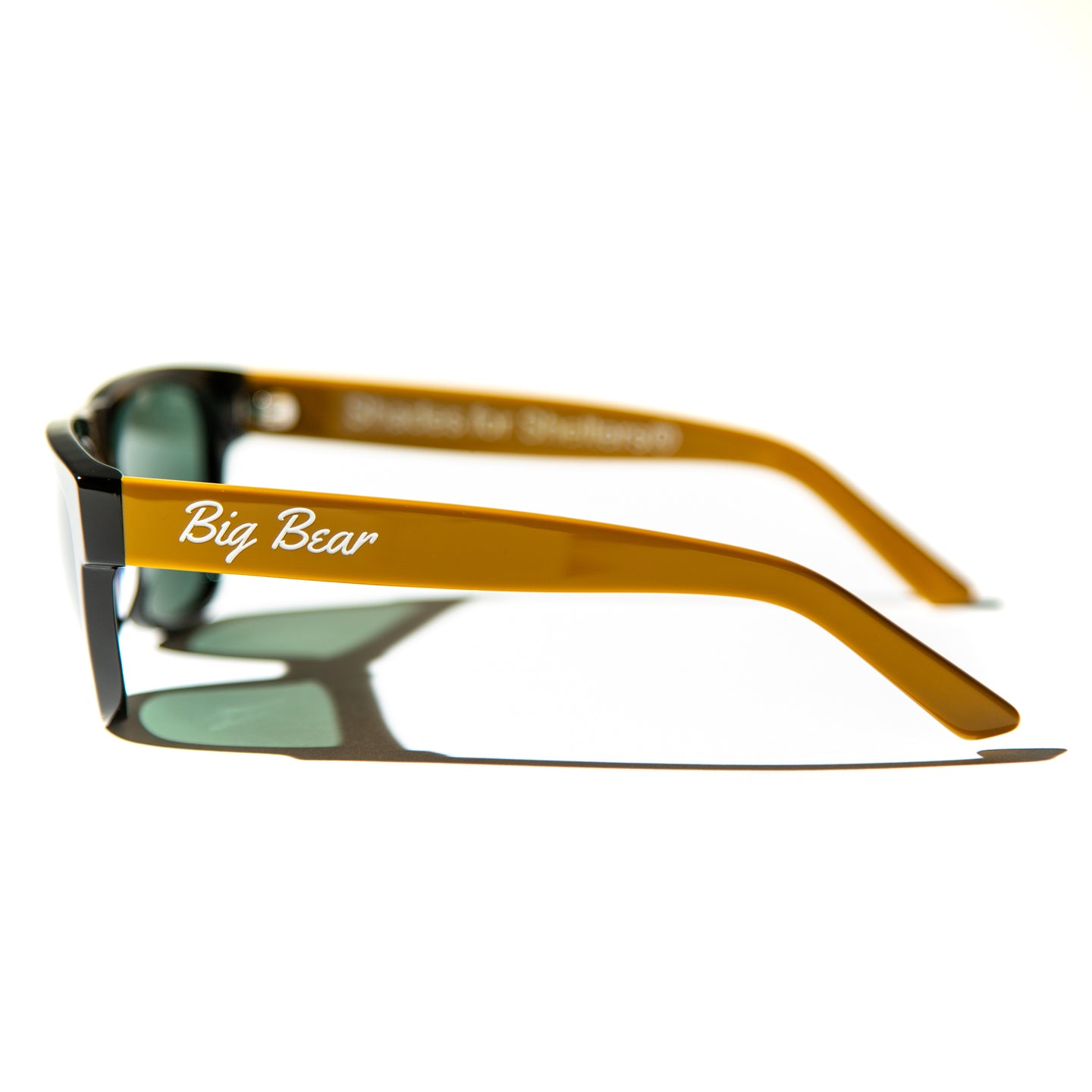 Green lens sunglasses with polished mustard yellow temples
