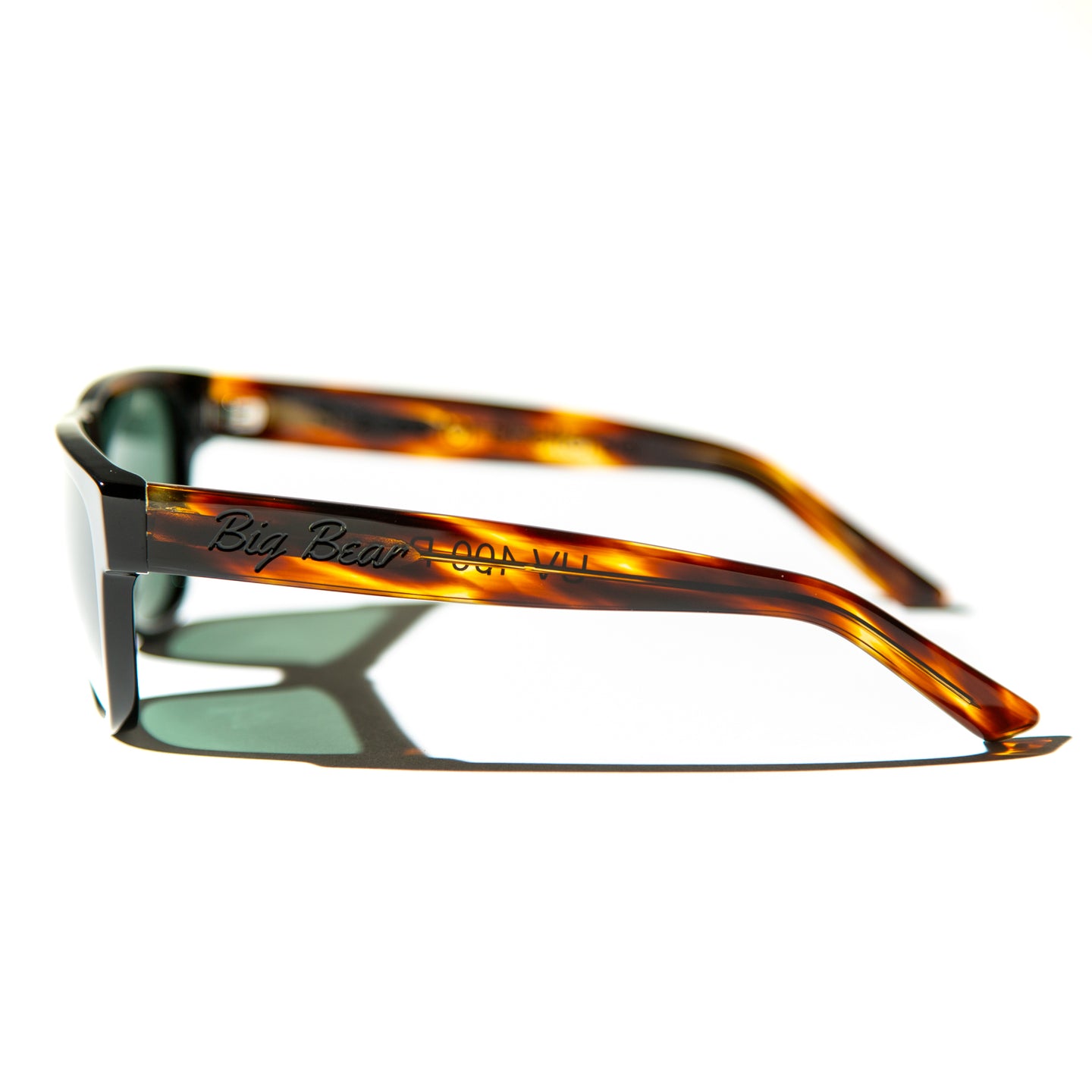 Green lens sunglasses with polished red havana temples