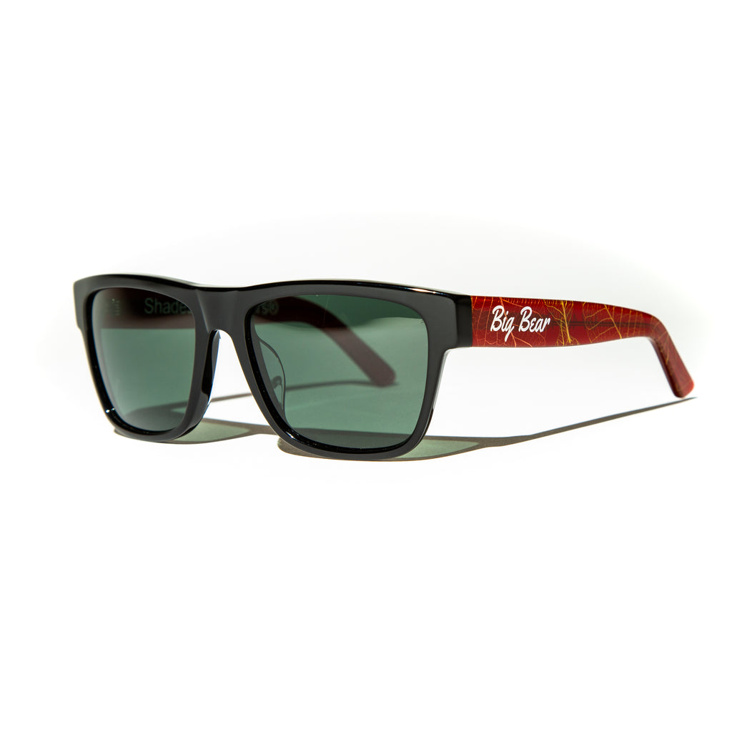 Green lens sunglasses with polished red and gold leaf temples