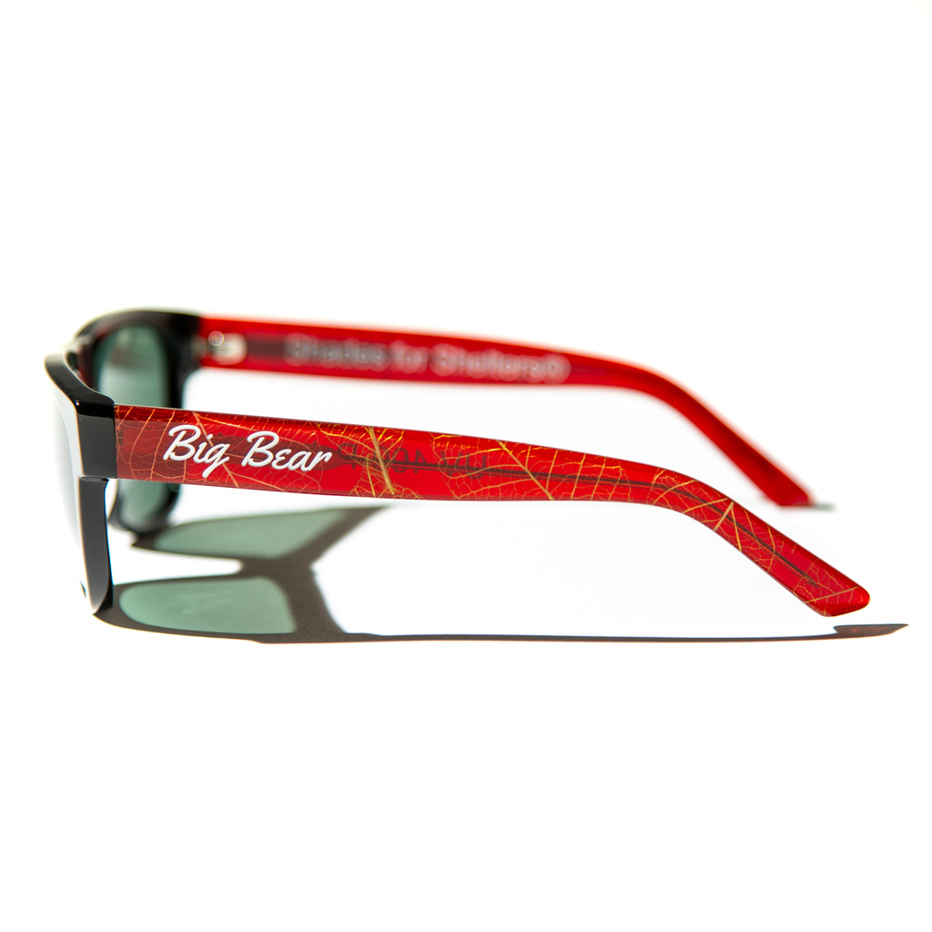 Green lens sunglasses with polished red and gold leaf temples