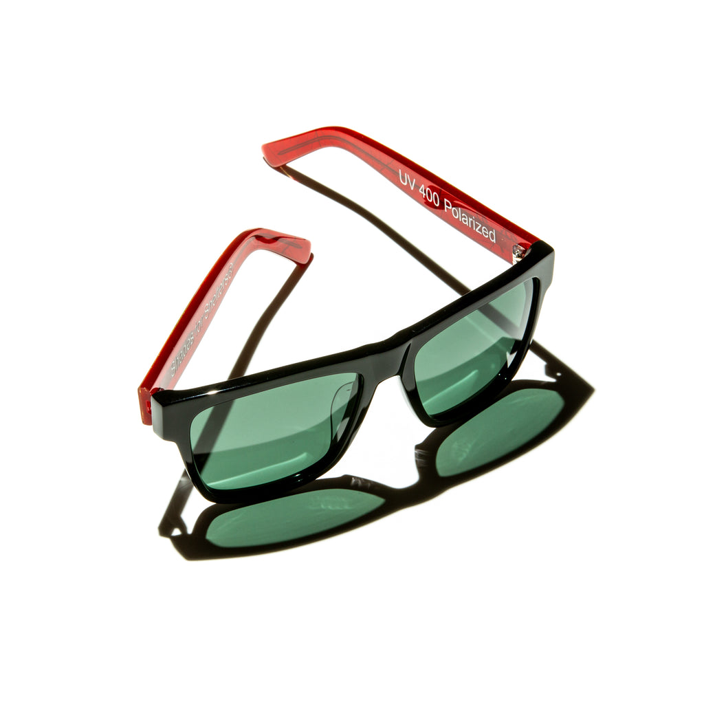 Green lens sunglasses with polished red and gold leaf temples