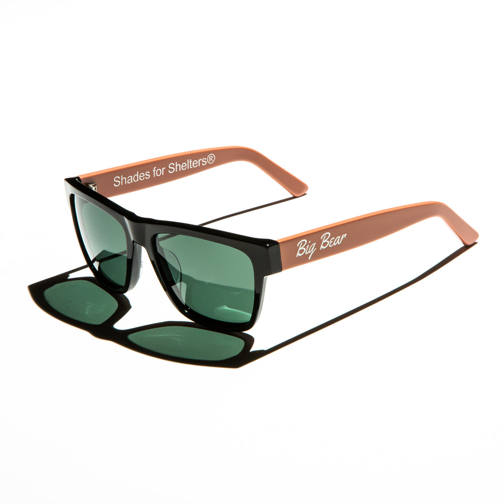 Green lens sunglasses with polished salmon pink temples