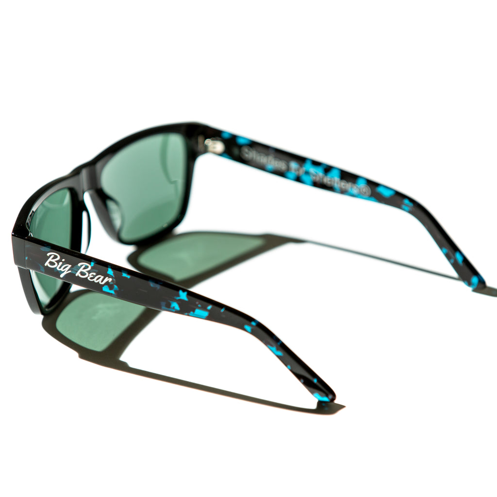 Green lens sunglasses with polished teal tortoiseshell temples