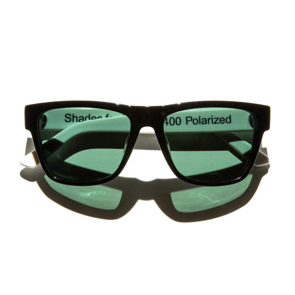 Green lens sunglasses with polished white temples